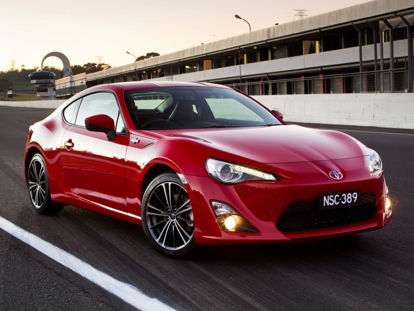 Toyota GT86 vermelho parado de frente na pista