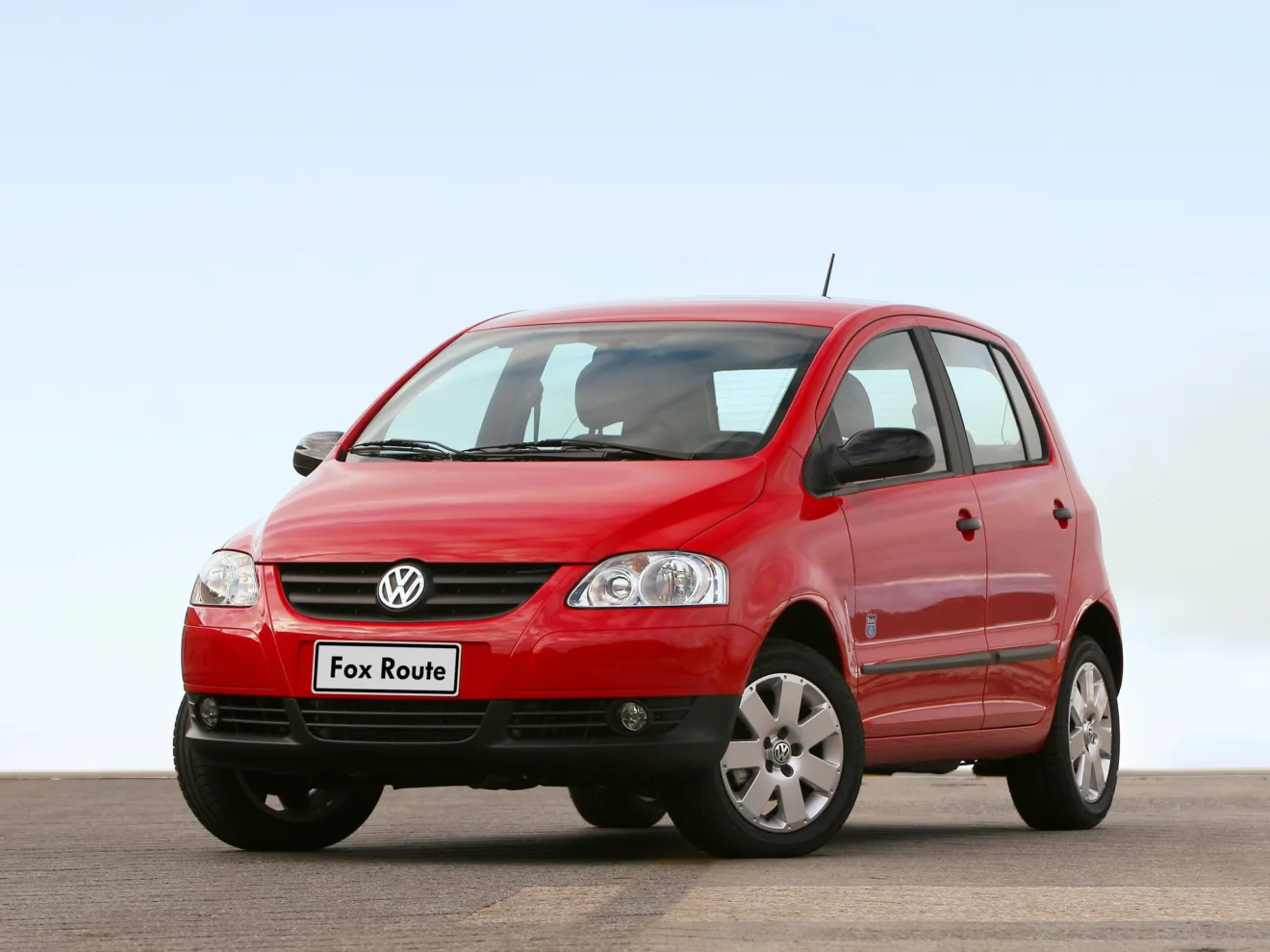 Volkswagen Fox vermelho parado de frente