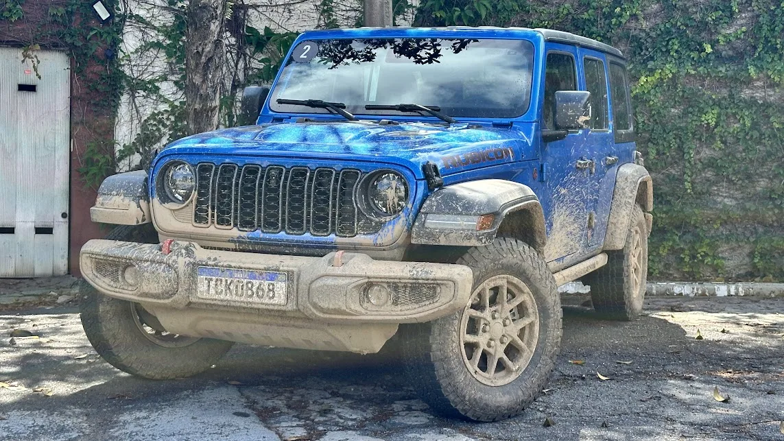 Jeep Wrangler azul parado de dianteira