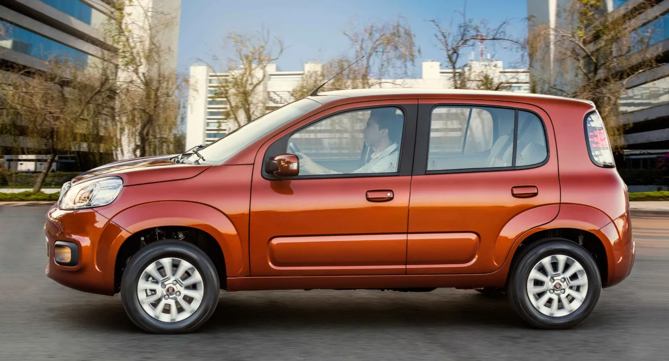 Fiat Uno Evolution com Start-Stop laranja de lateral em movimento