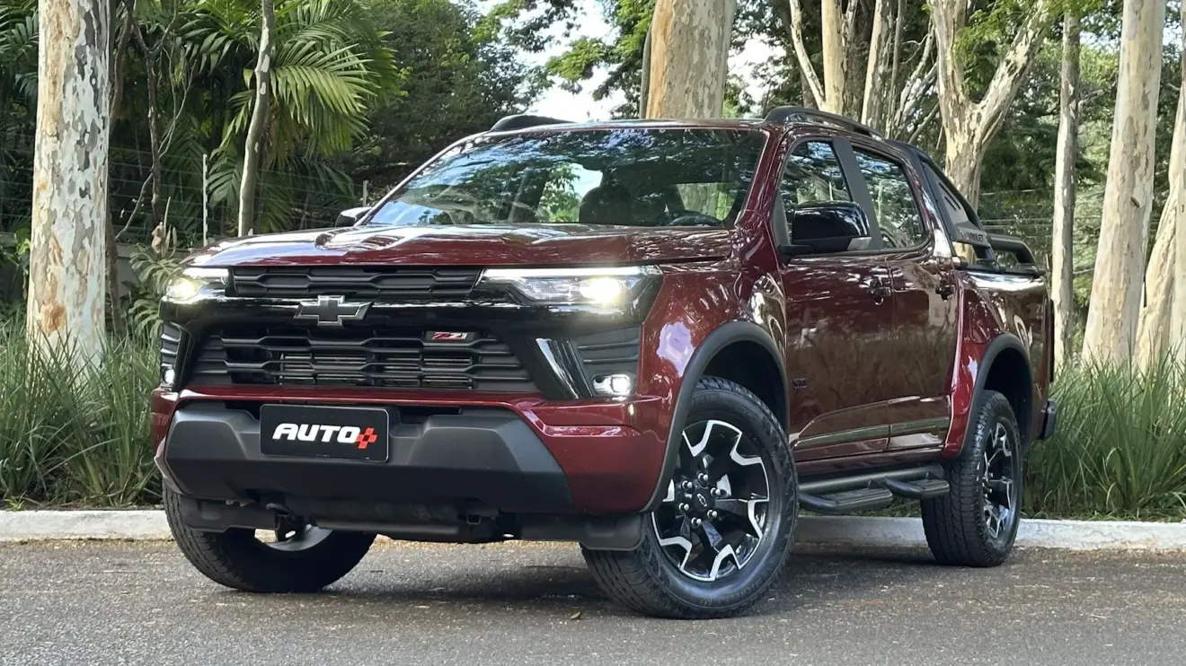 Chevrolet S10 Z71 vermelha parada de frente e lateral com árvores ao fundo