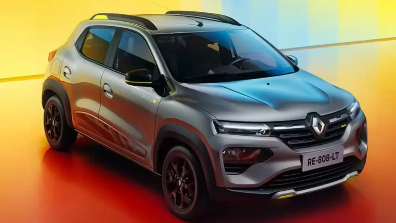 Renault Kwid Outsider 2026 cinza com detalhes pretos e amarelos, fundo laranja e visto de frente - Carros mais econômicos em 2025