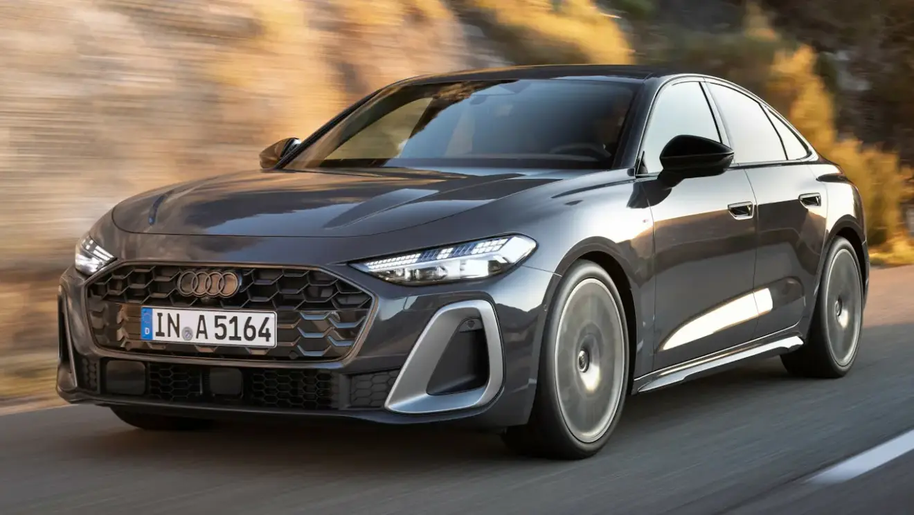 Novo Audi A5 2026 cinza com detalhes claros, faróis acesos e visto de lado andando