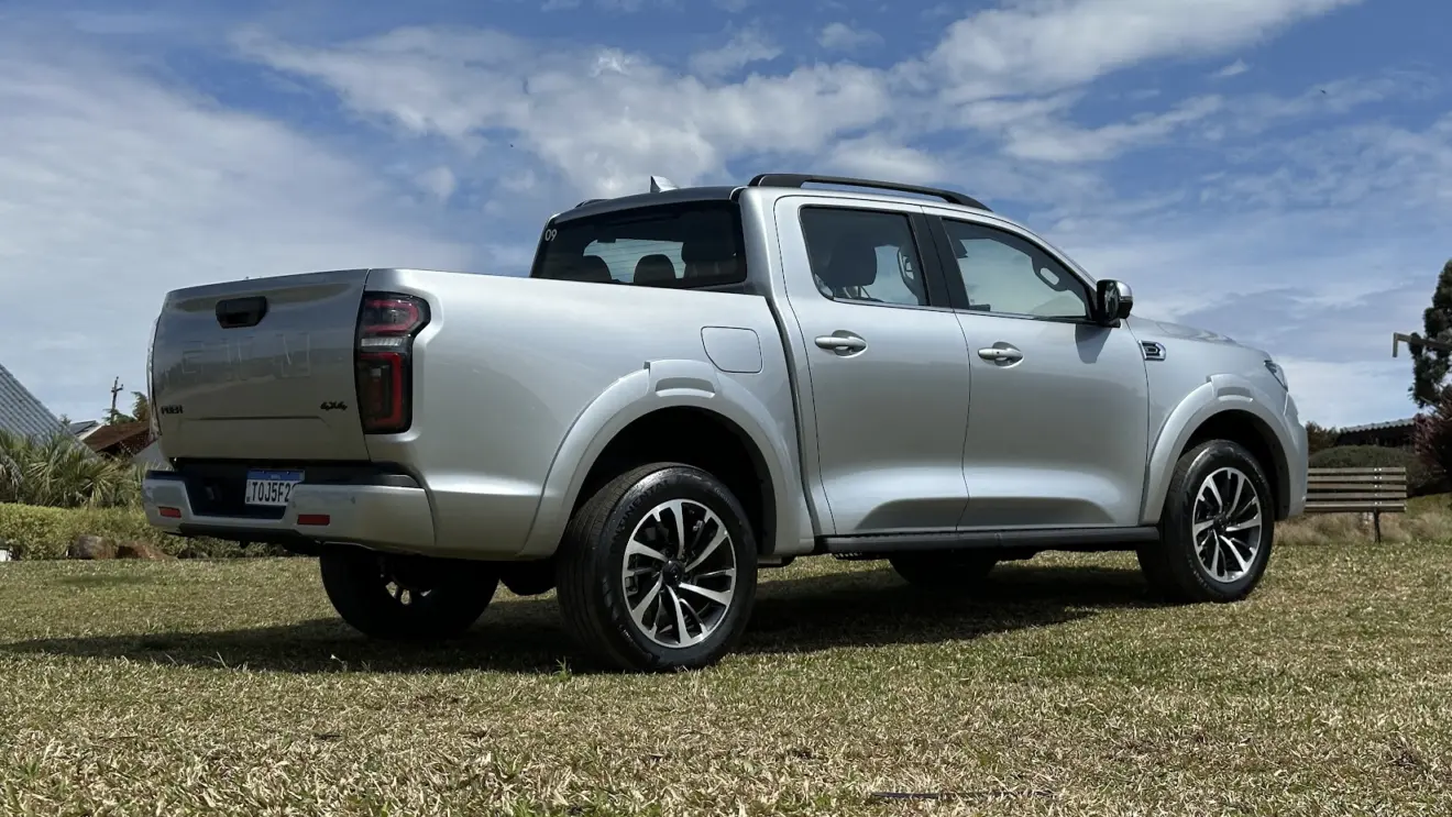 GWM Poer P30 Exclusive prata estacionada de traseira na grama