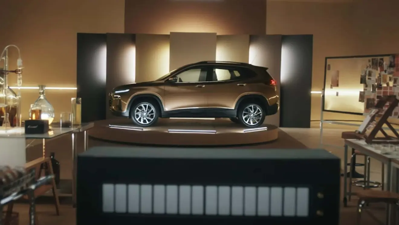 Chevrolet Tracker caramelo visto de lado e com iluminação acesa