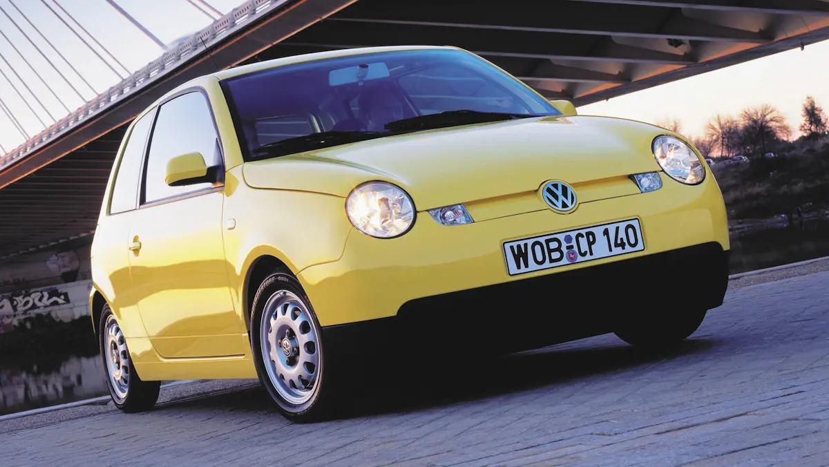 Volkswagen Lupo 3 L amarelo parado de frente 