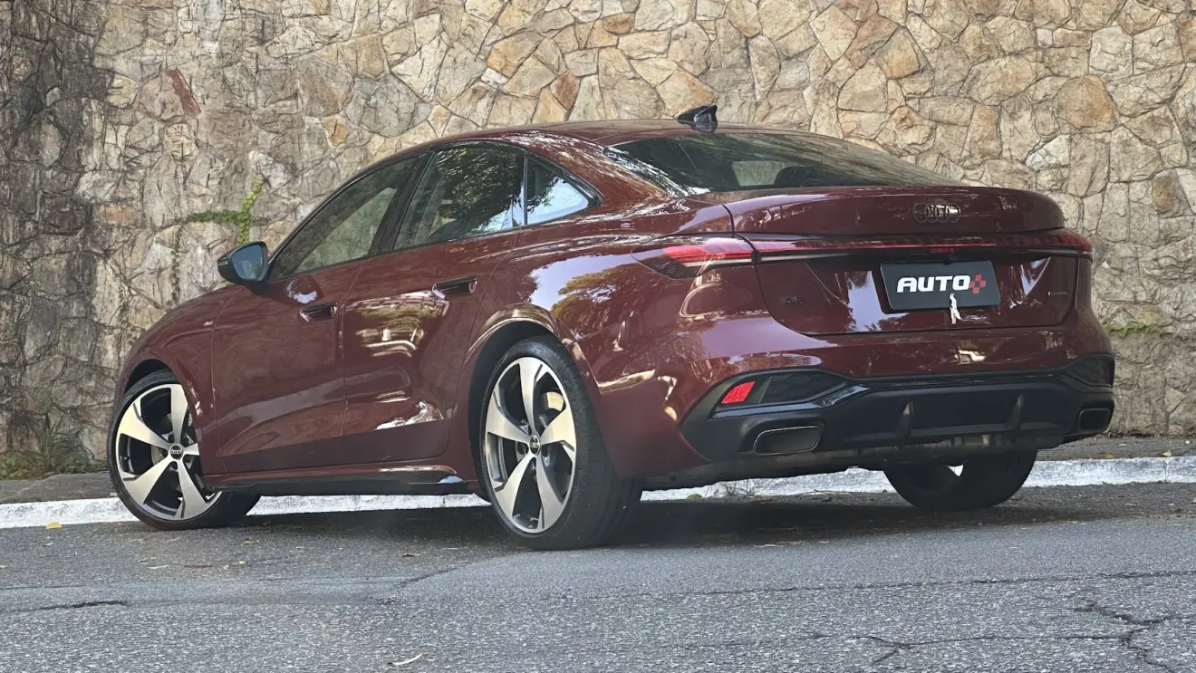 Audi A5 Performance S Edition vermelho parado de traseira com muro de pedras ao fundo