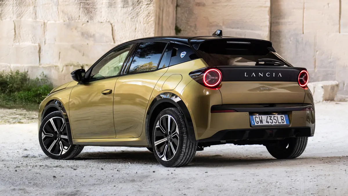 Lancia Ypsilon dourado de traseira em meio a pedras