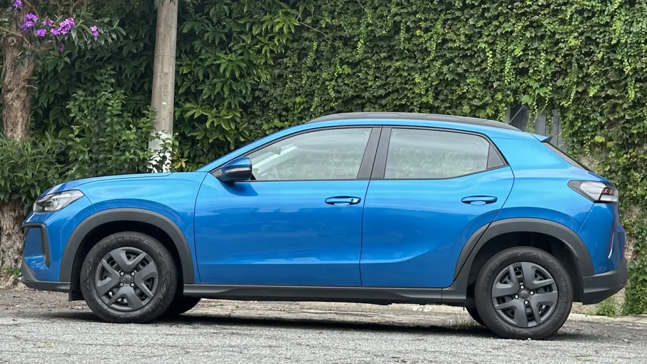 Volkswagen Tera MPI azul Ártico parado de lateral com muro de plantas ao fundo