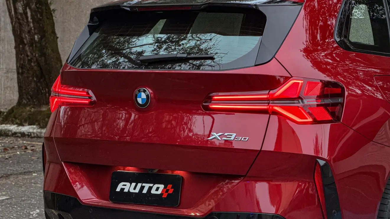 Detalhes do BMW X3 estático na cor Vermelho Fire no asfalto para teste e avaliação