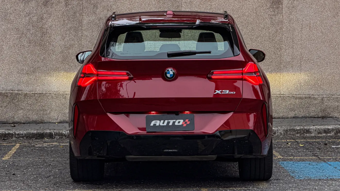 BMW X3 estático na cor Vermelho Fire no asfalto para teste e avaliação