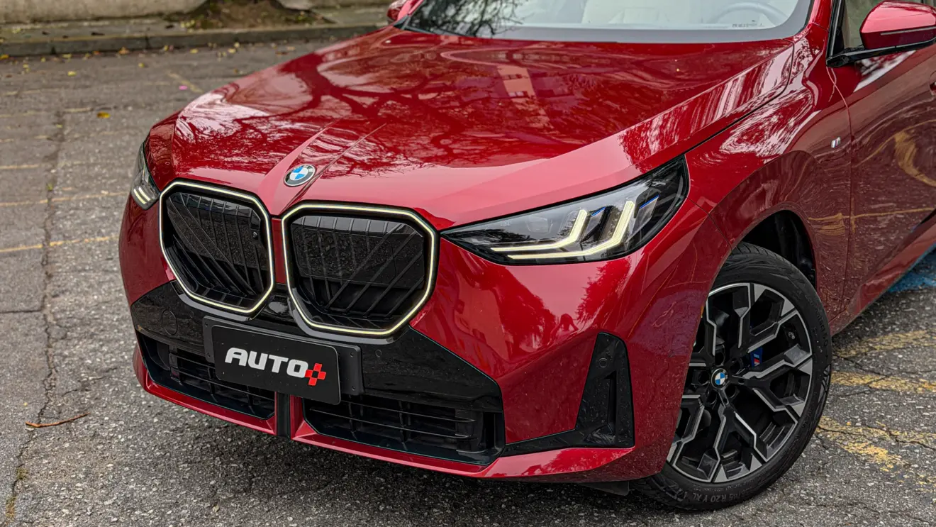 Detalhes do BMW X3 estático na cor Vermelho Fire no asfalto para teste e avaliação
