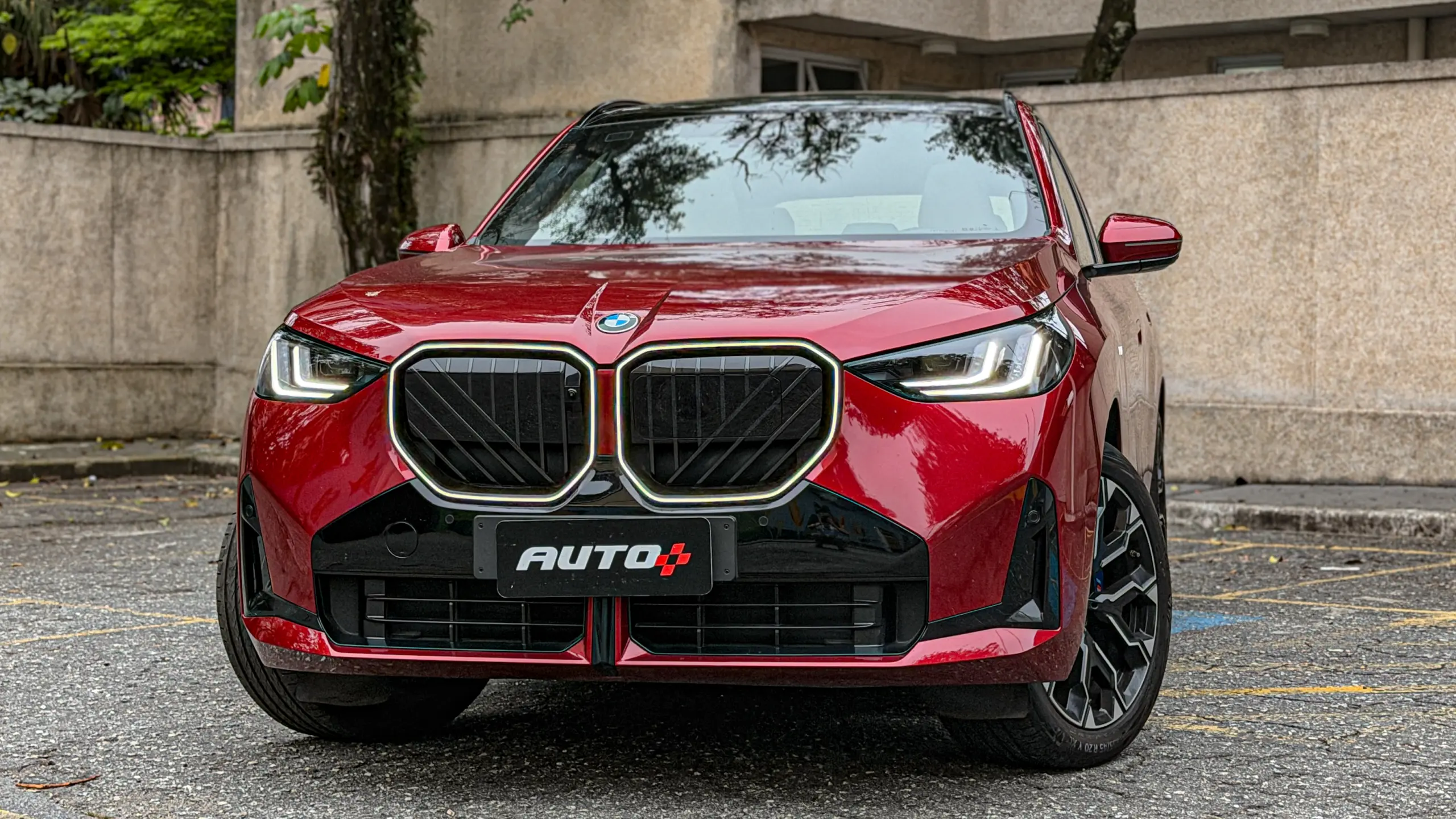 BMW X3 estático na cor Vermelho Fire no asfalto para teste e avaliação
