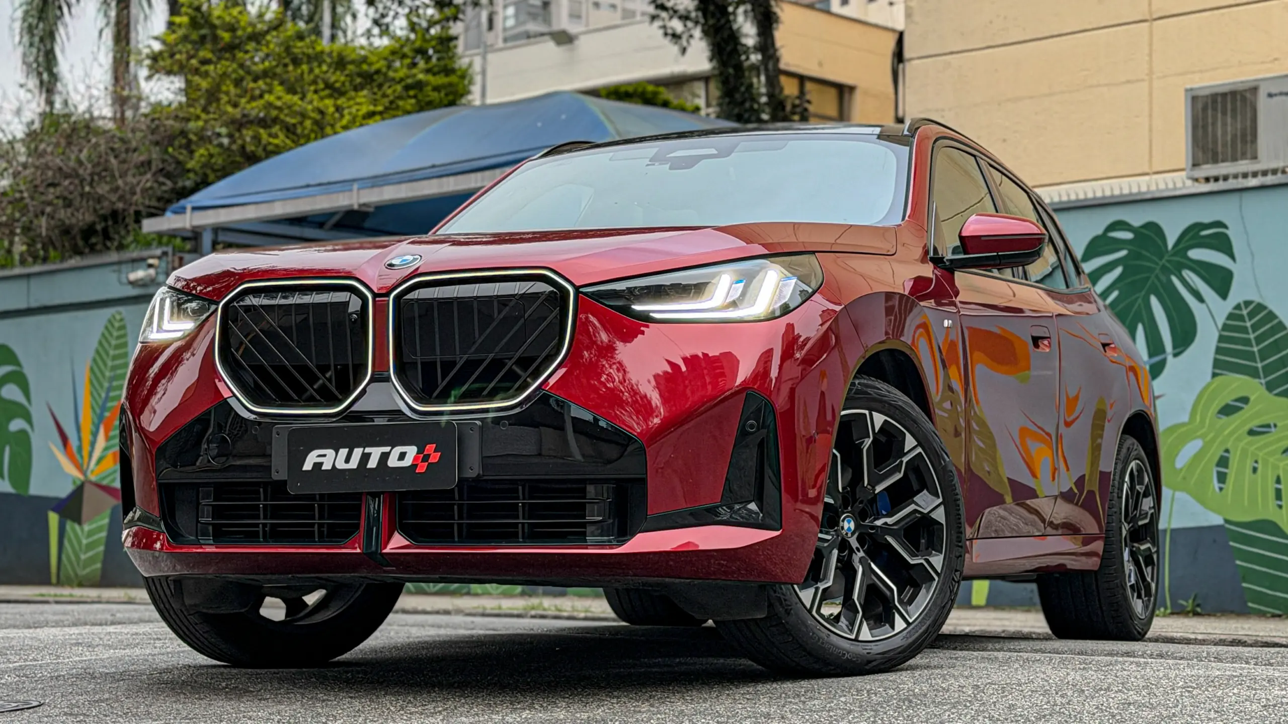 BMW X3 estático na cor Vermelho Fire no asfalto para teste e avaliação